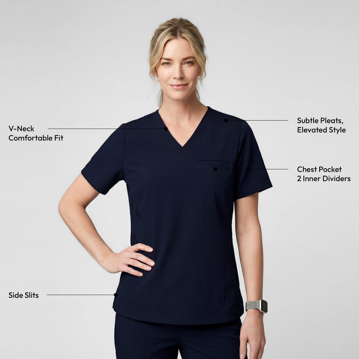Smiling in the Women's Eco Navy Pleated Shoulder Scrub Top and pants, holding a navy backpack, upper body view