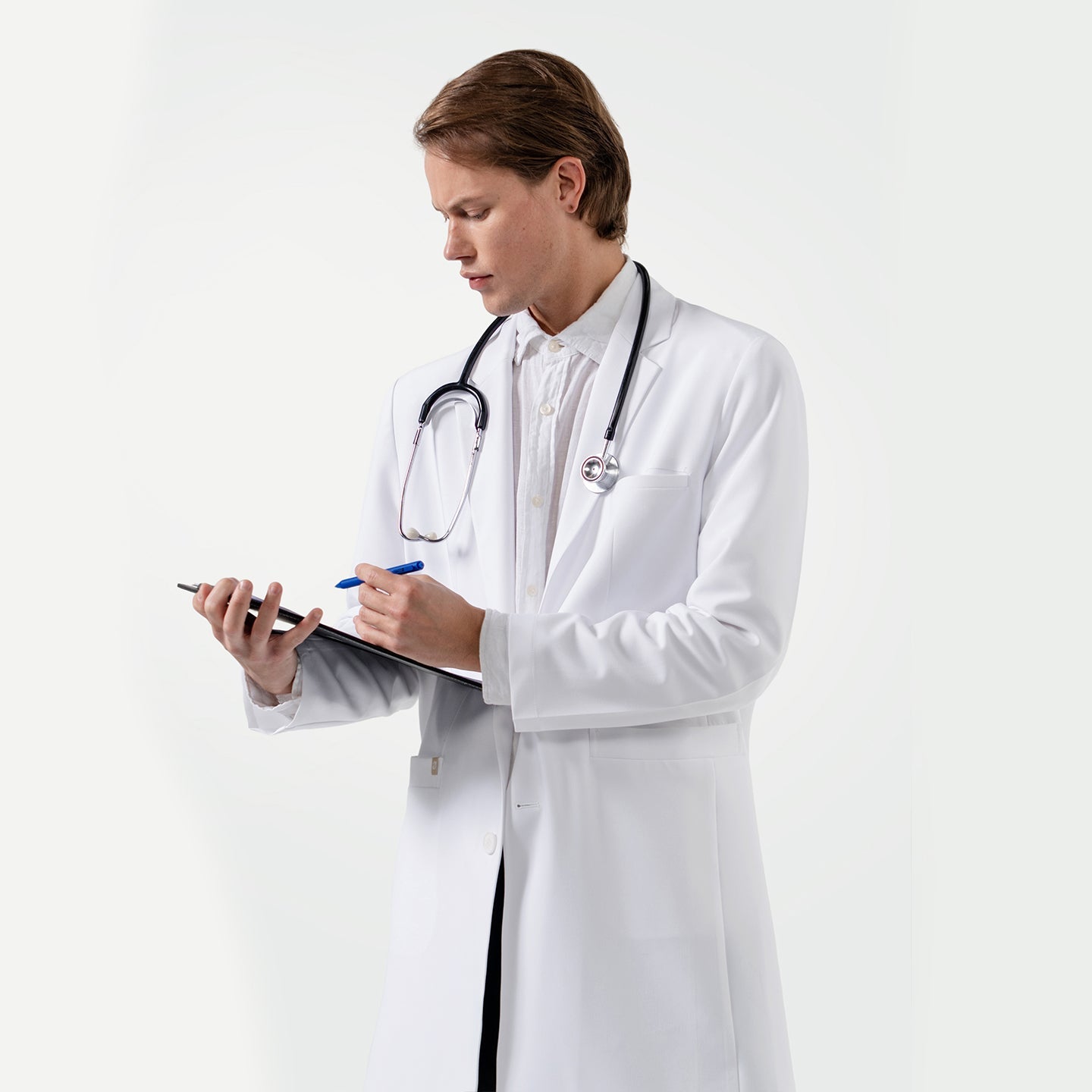Doctor in a white coat with a stethoscope, holding a clipboard and pen on a white background