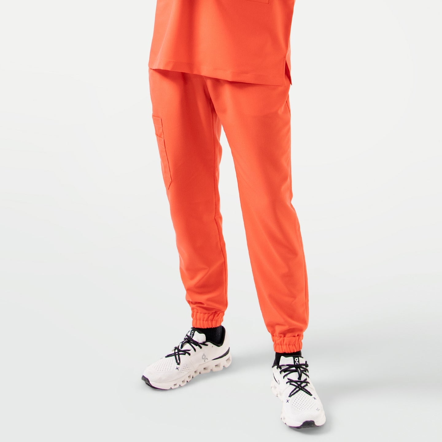 Tiger Orange StretchFit jogger scrub pants in a front view, featuring an elastic waistband, cuffed hems, and a practical side cargo pocket.