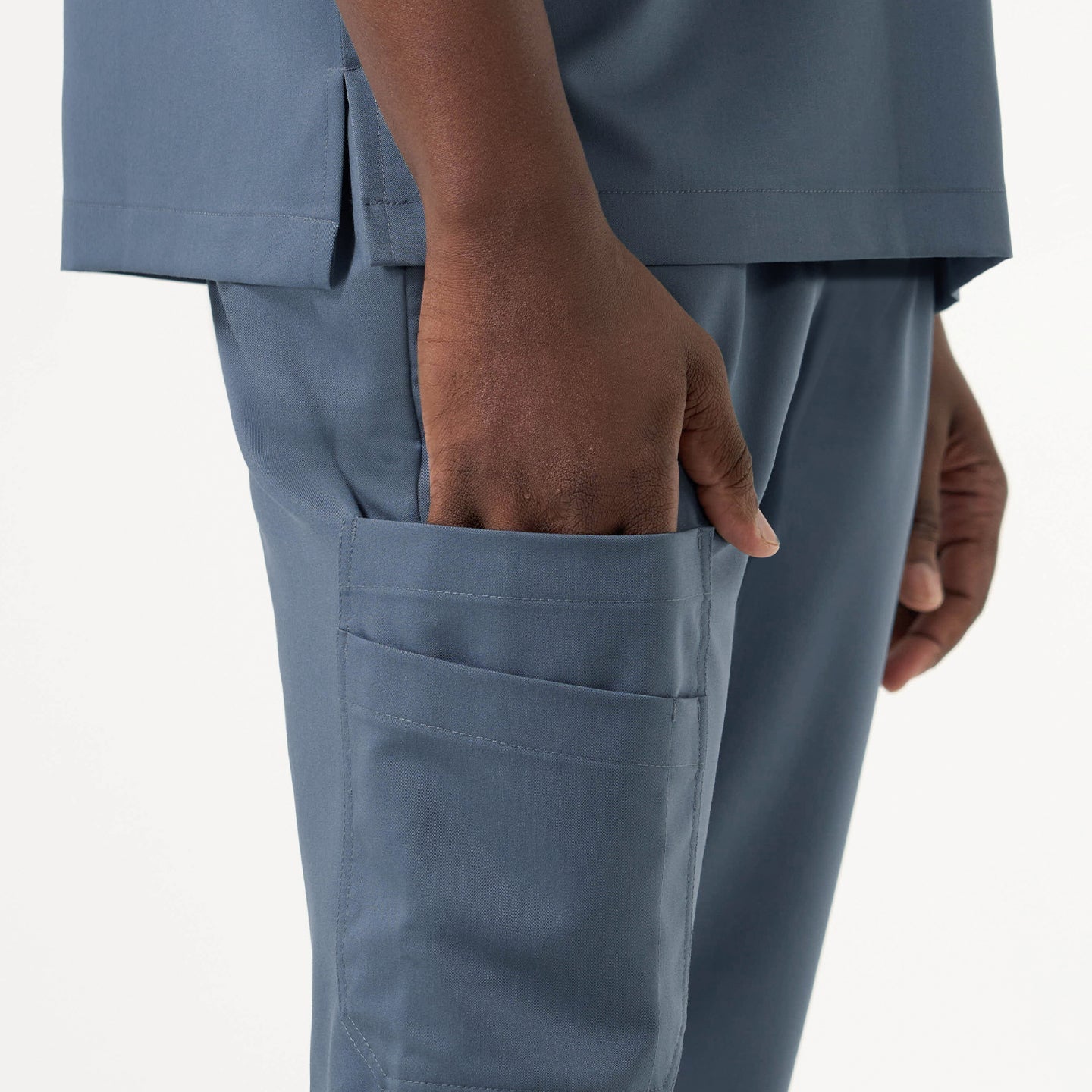 Side view highlighting the practical storage pocket on the Smoky Blue jogger scrub pants.
