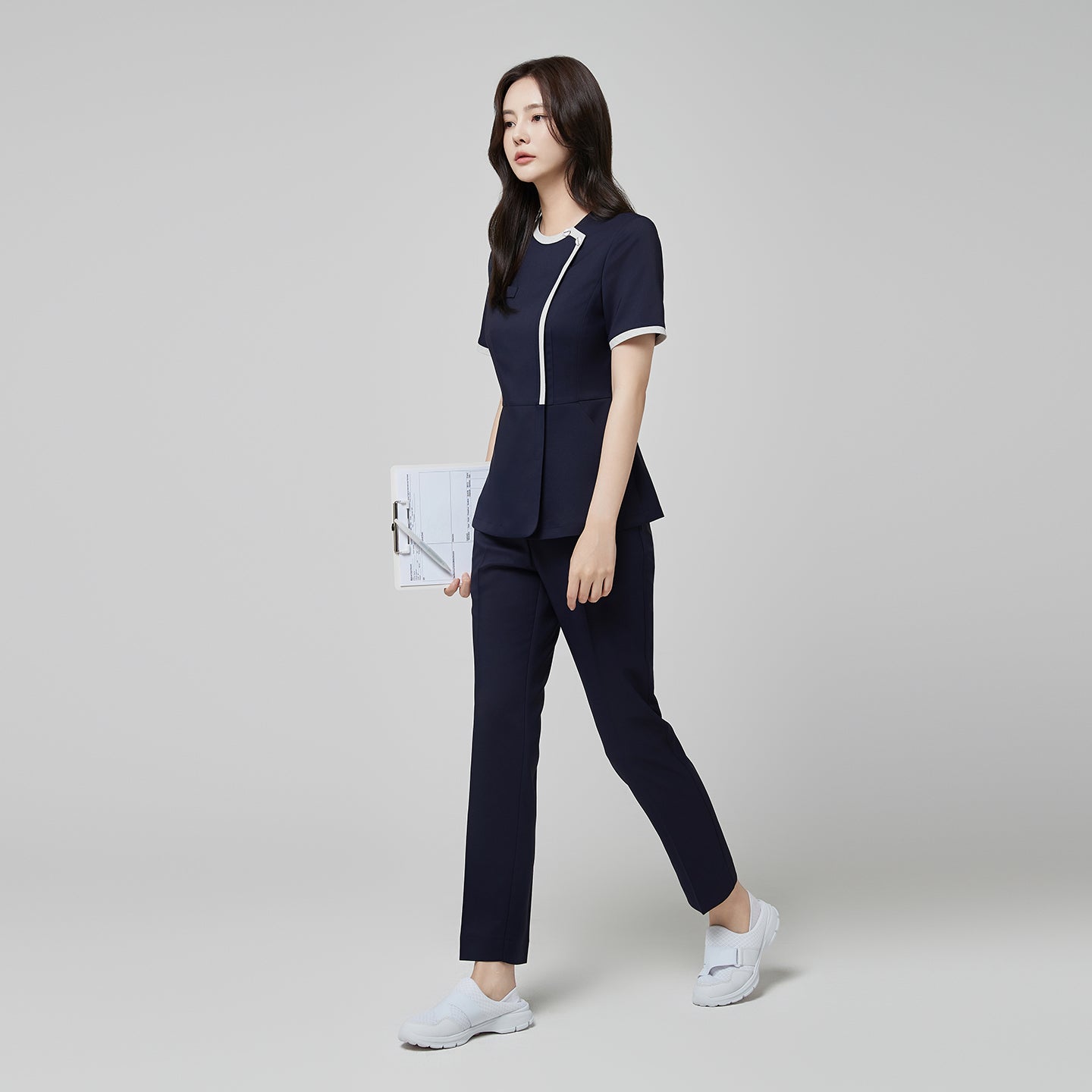 Full-length view of TUL NS-174 Mir Navy scrub top with check gray accents, paired with matching pants for a cohesive professional uniform.
