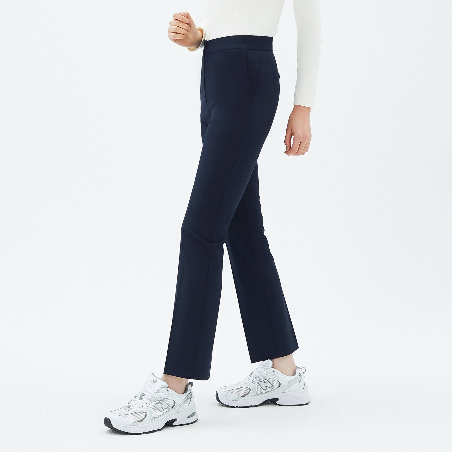 Angled shot of TUL Women’s Side Hidden Banding Pants in Mir Navy, highlighting a tailored design and flexible side band for ease of movement.