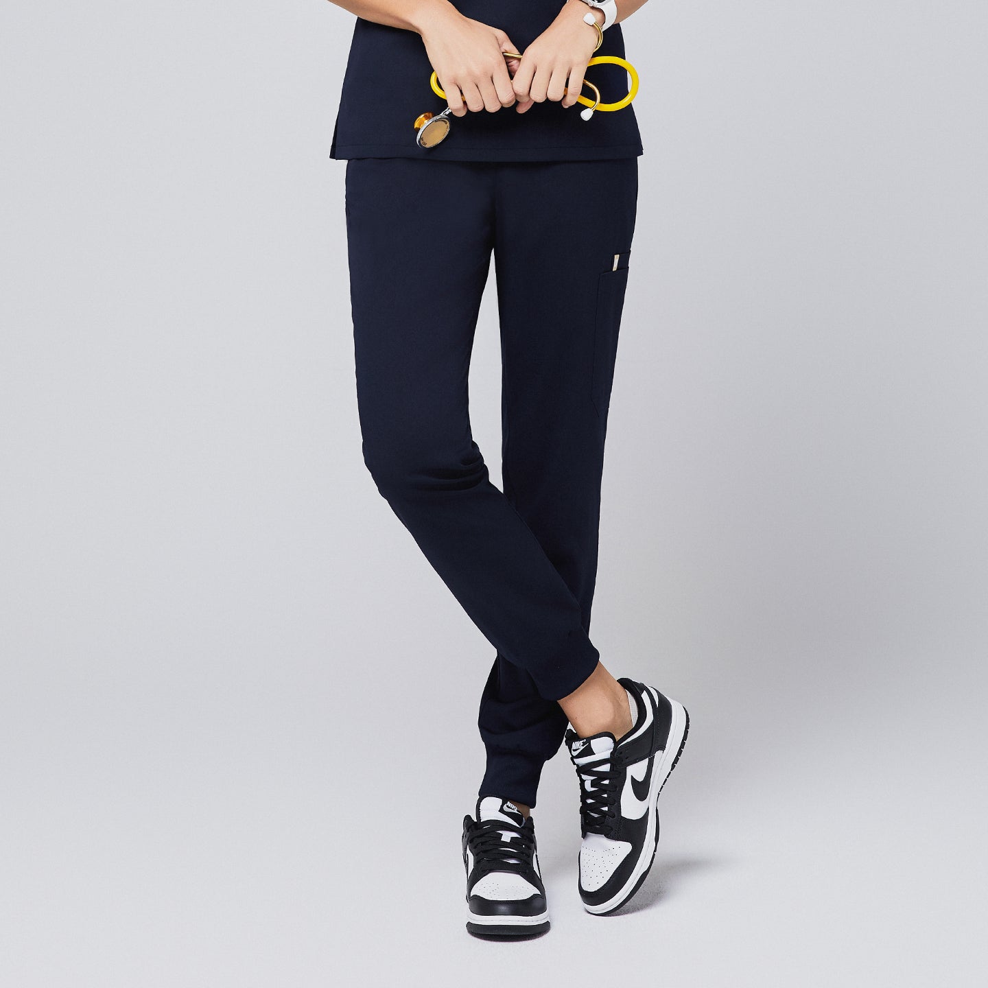 Elegant navy jogger scrub pants paired with a matching top, designed for healthcare professionals, showcasing practicality and style,Navy