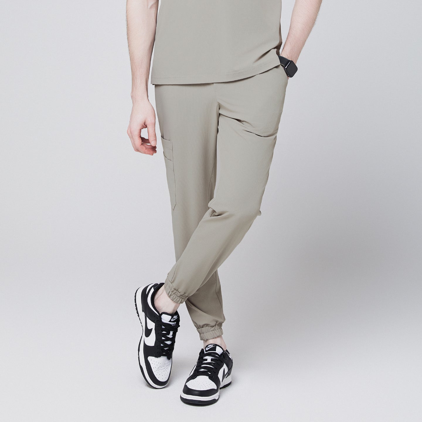 Sand khaki jogger scrub pants with side pocket and elastic cuffs, paired with black and white sneakers,Sand Khaki