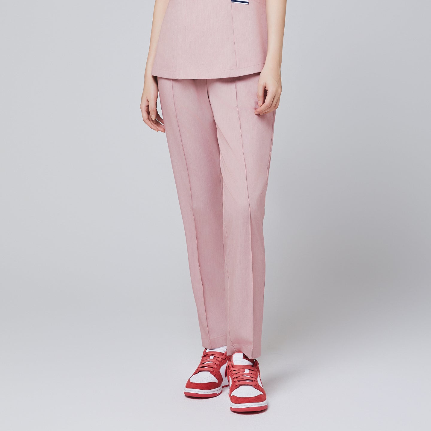 Soft pink banding scrub pants with straight-leg design, styled with red sneakers for a professional and modern look,Soft Pink