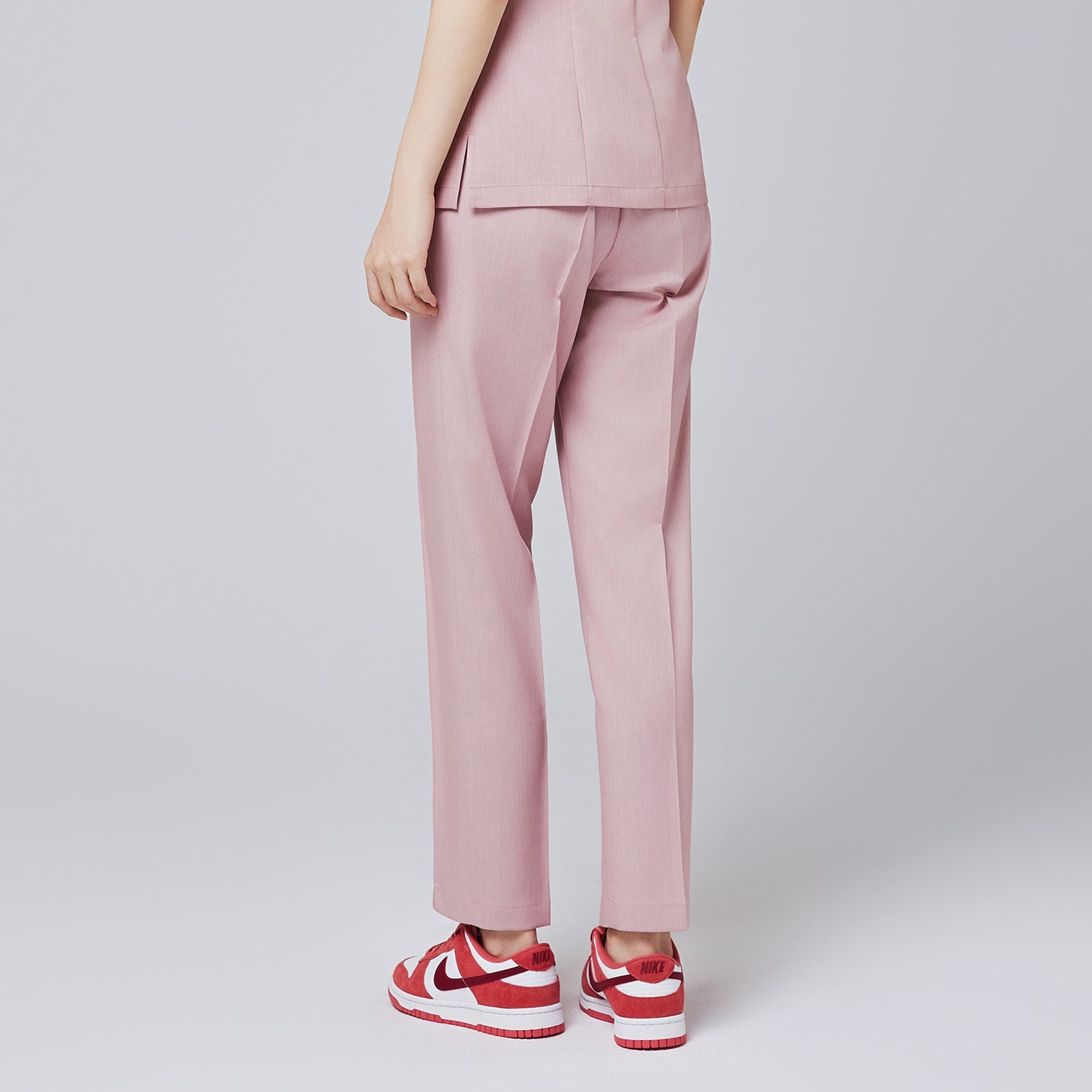 Back view of soft pink banding scrub pants with straight-leg fit, paired with red Nike sneakers,Soft Pink