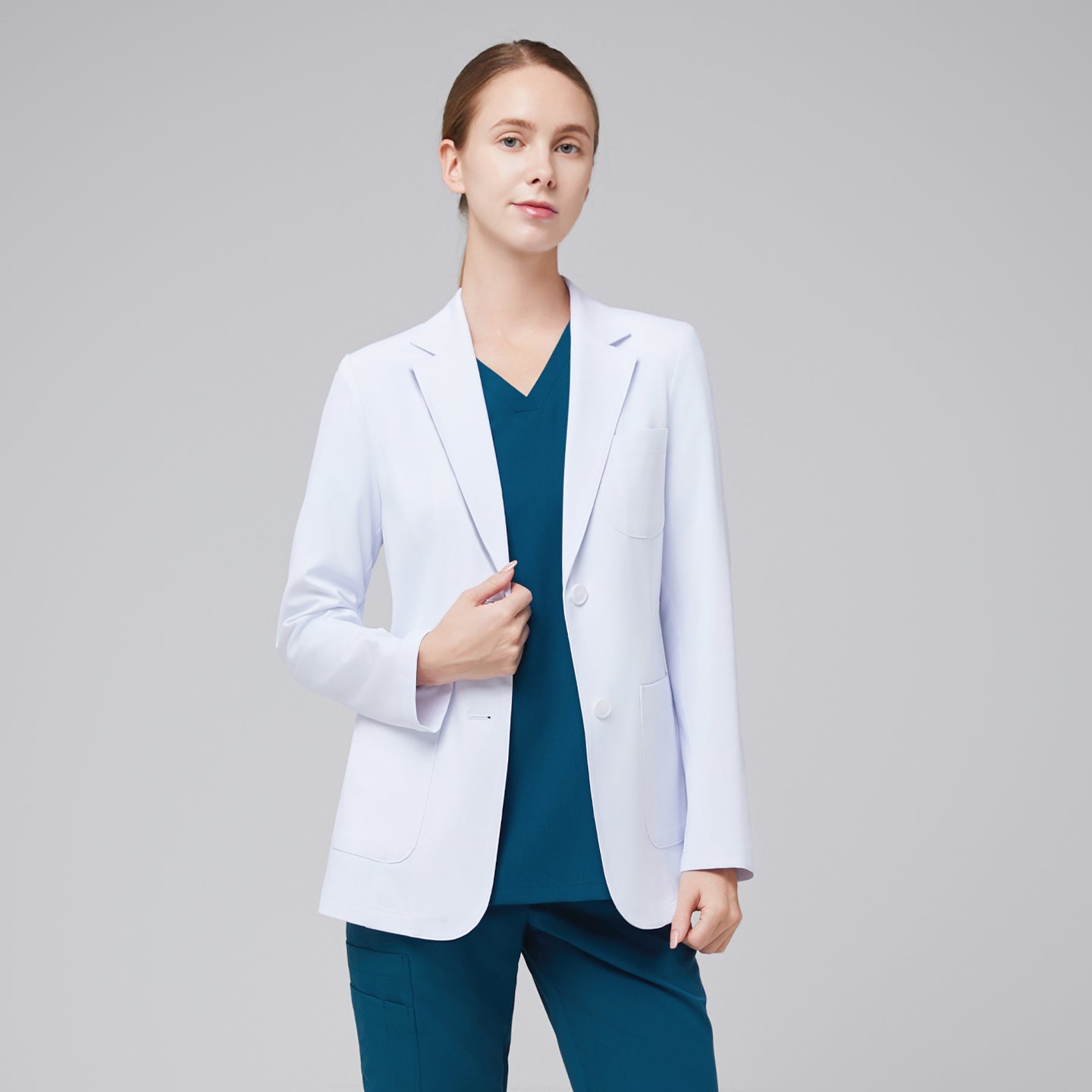 White lab coat Zenir, model wearing with clean two-button front and tailored long-sleeve fit.
