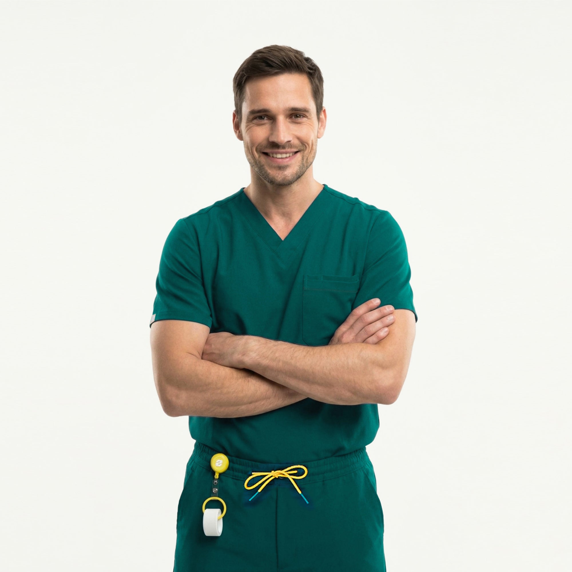 Wearing a Pine Green 3 Pocket Scrub Top, the model sits comfortably with a slight smile.
