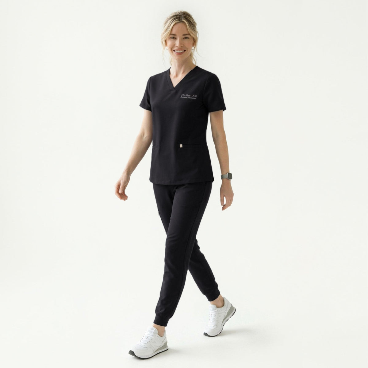 Woman in a black scrub top holding a Zenir-branded mug, wearing a stethoscope and matching black scrub pants,Eco Black