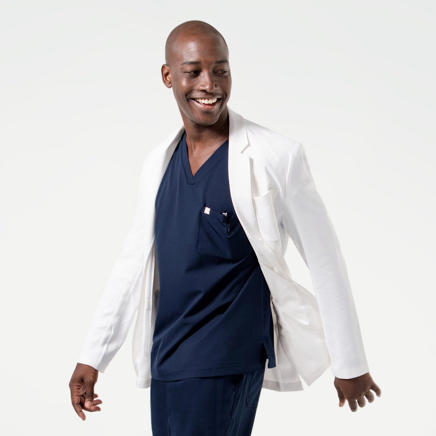In motion, the model showcases the flexibility and tailored fit of the Men’s LCM-100 Lab Coat.