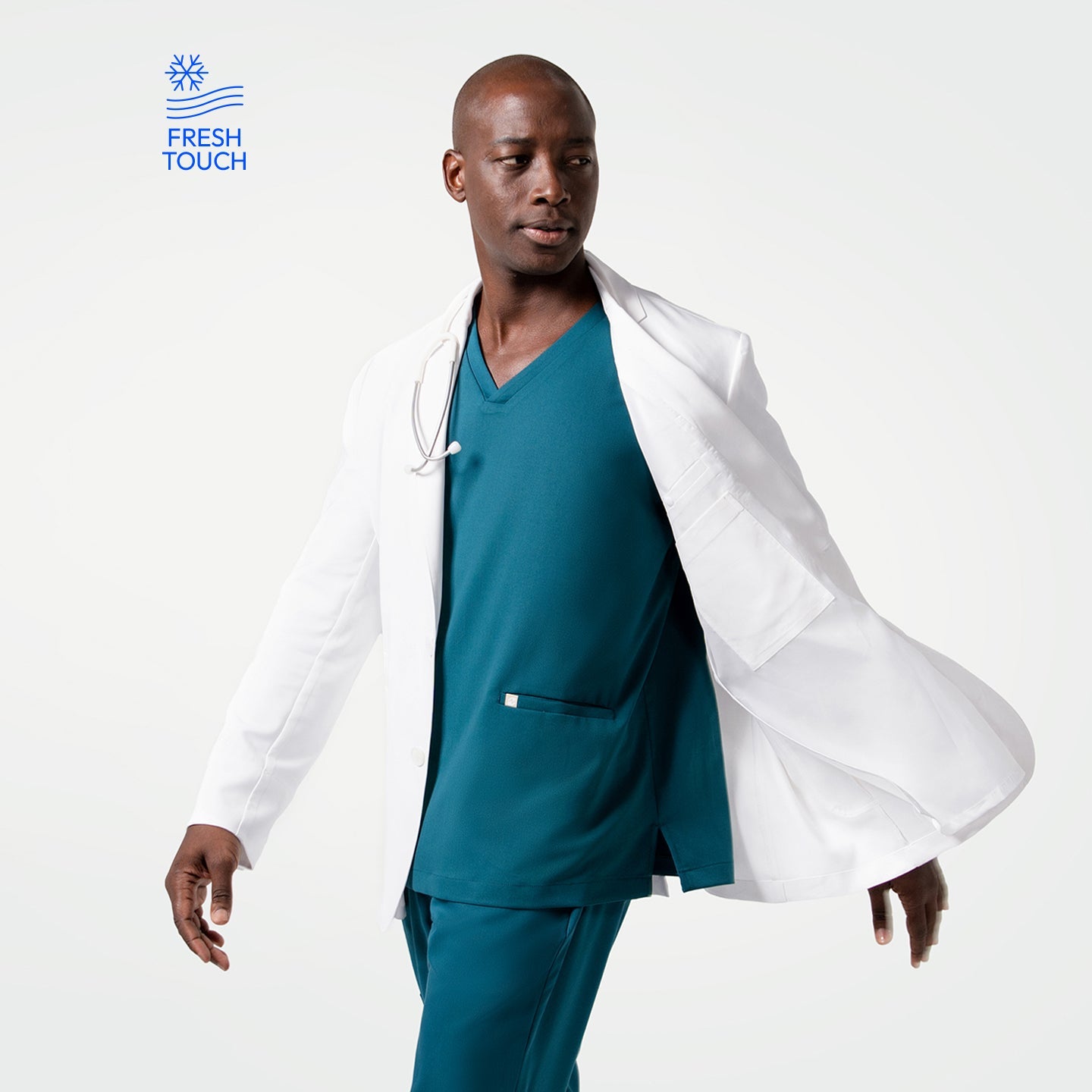 In motion wearing the Men's LCM-102 Lab Coat in White over medical scrubs, looking to the side with the coat flowing behind