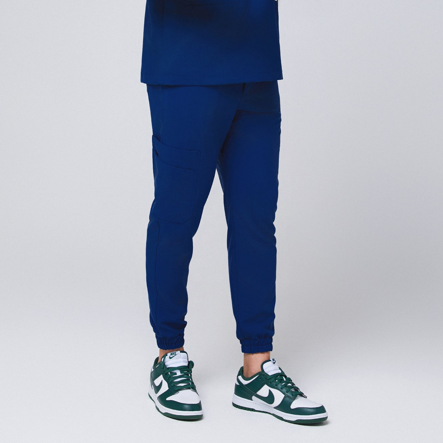 Admiral Blue StretchFit Jogger Scrub Pants with tapered jogger fit, elastic cuffs, and side cargo pocket, made from flexible stretch fabric.
