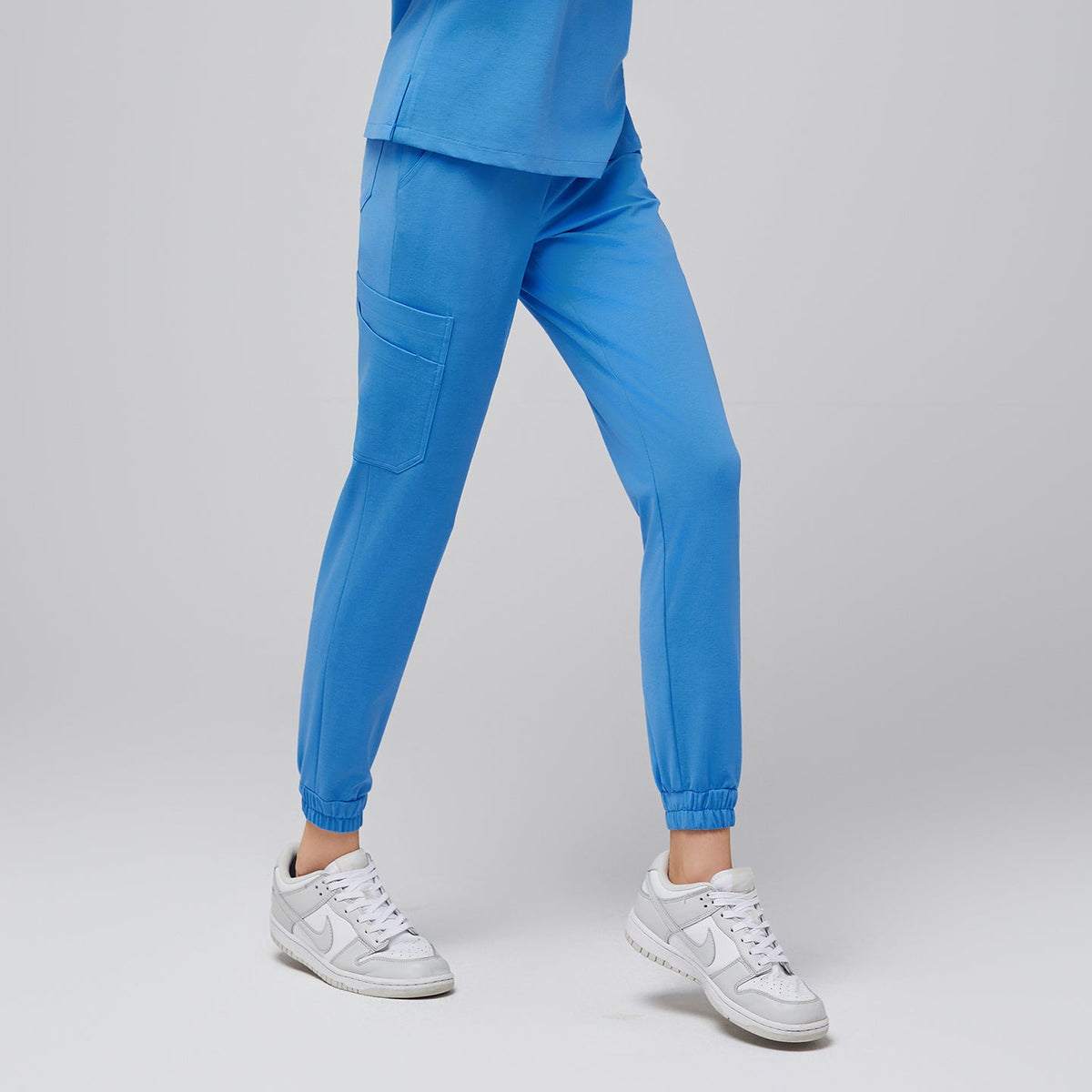 Aqua Blue StretchFit Jogger Scrub Pants featuring slim jogger fit with elastic cuffs and utility pocket, lightweight stretch fabric ideal for medical professionals.