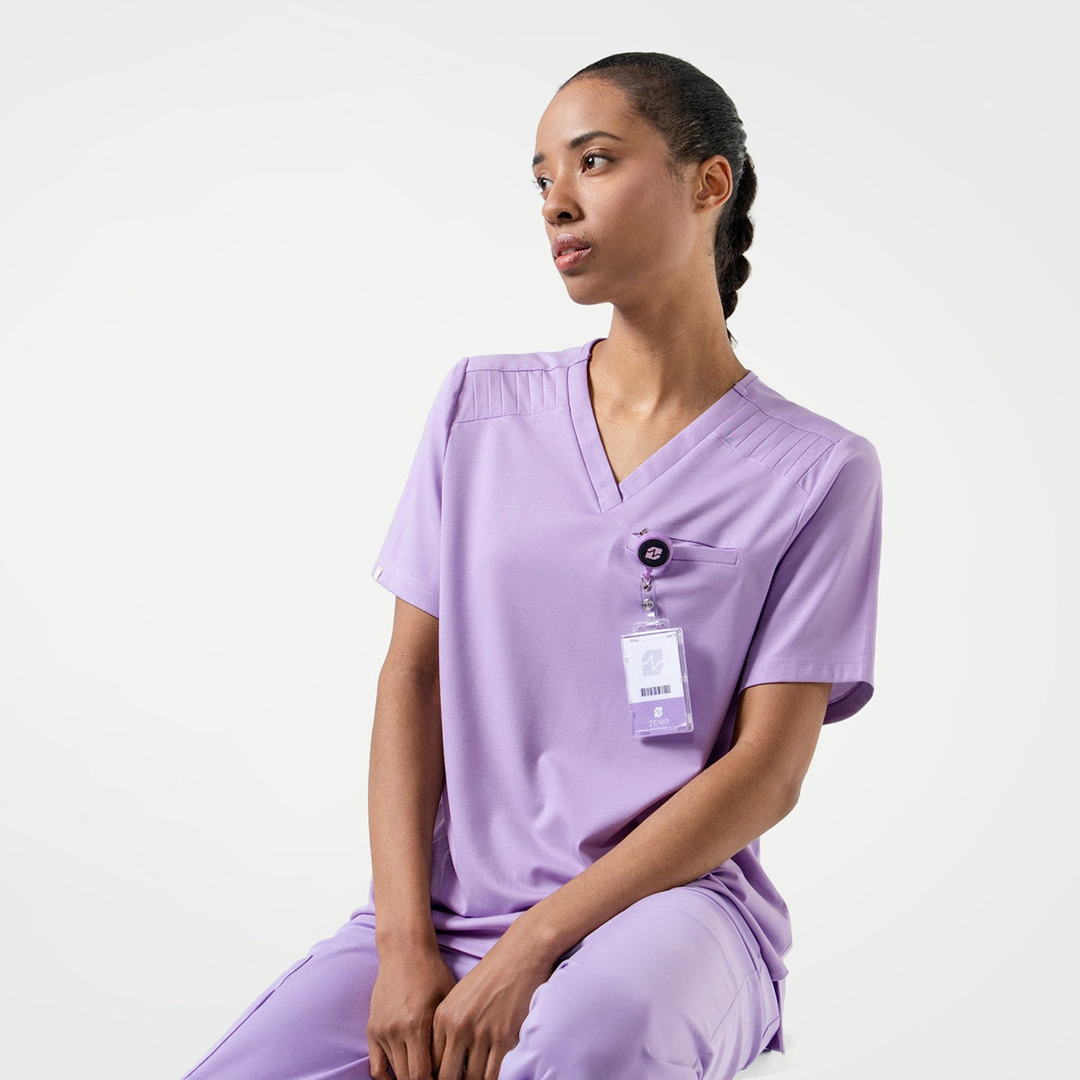 Lavender  scrub top with shoulder details, paired with matching scrub pants