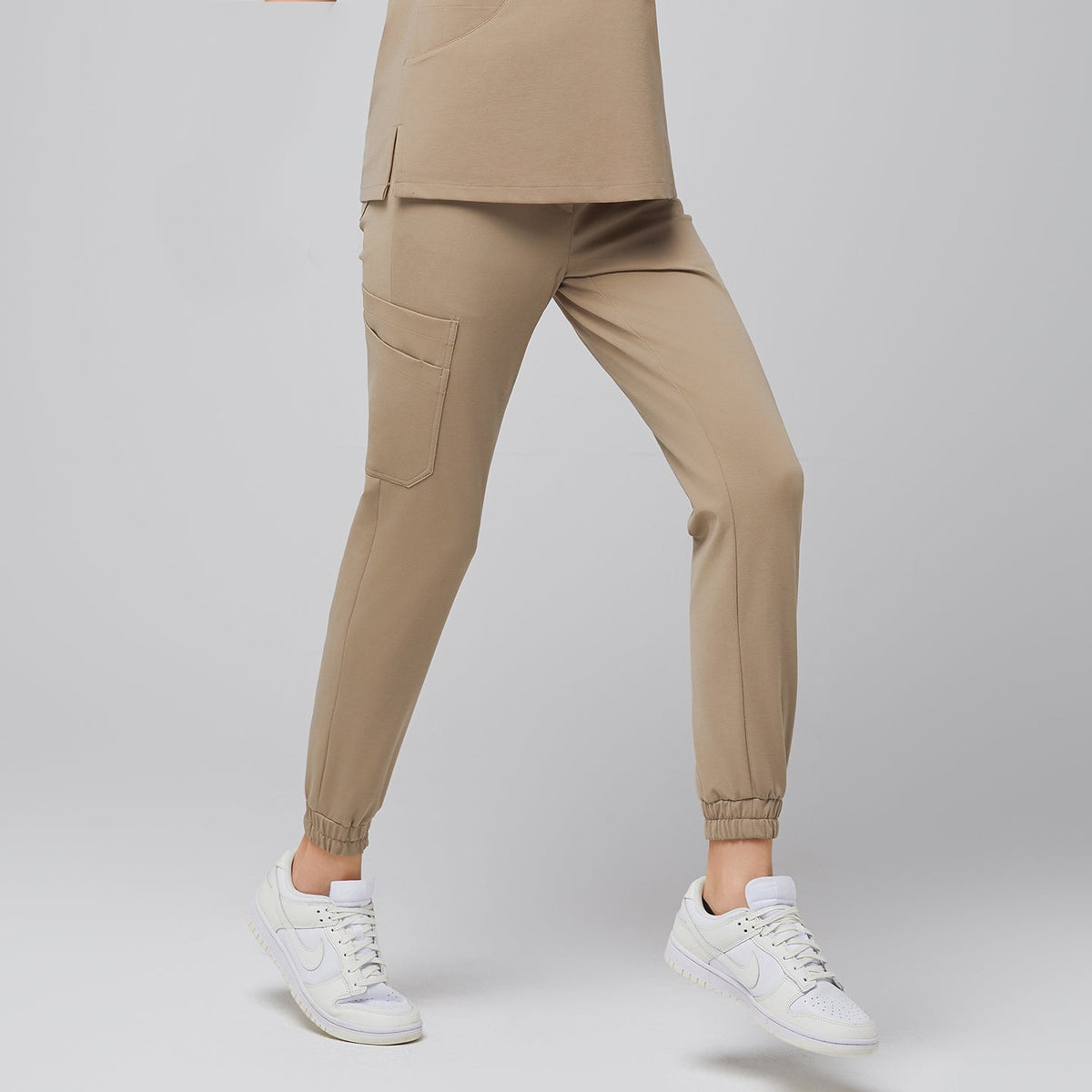 Sand Beige StretchFit Jogger Scrub Pants made with flexible stretch fabric, featuring tapered legs, elastic cuffs, and side cargo pocket for everyday comfort.