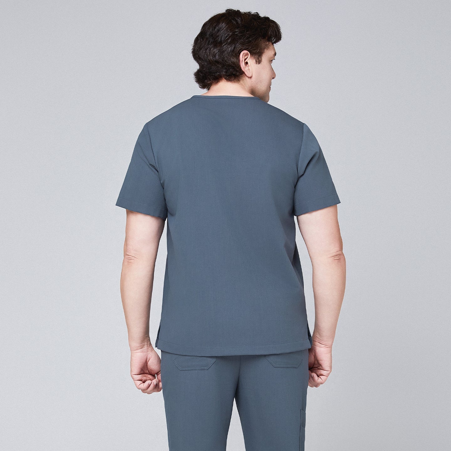 Back view of a man wearing a smoky blue scrub set with a clean, minimalist design,Smoky Blue