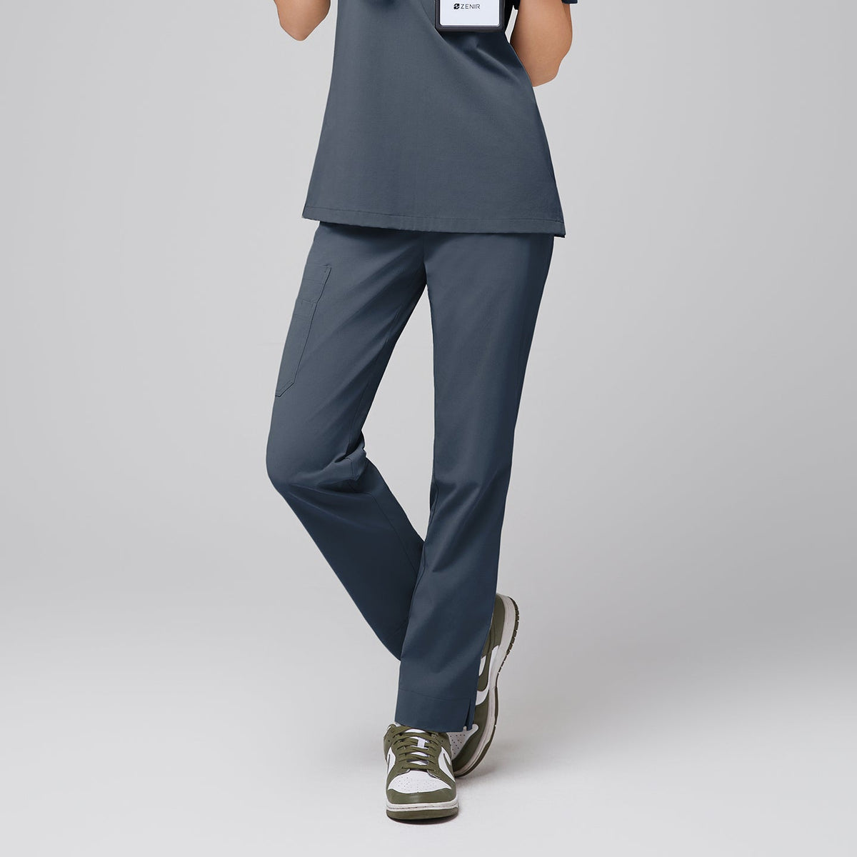 Front view of Zenir Smoky Blue straight scrub pants with a split hem and functional side pocket, paired with green sneakers for a sleek look,Smoky Blue.