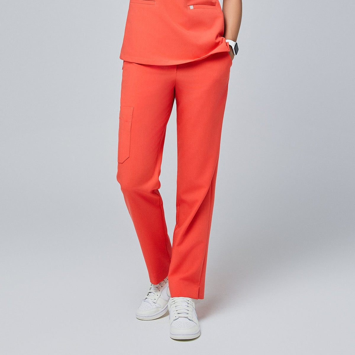 Bright tiger orange straight-leg scrub pants with a split hem and side cargo pocket, paired with white sneakers on a neutral background,Tiger Orange