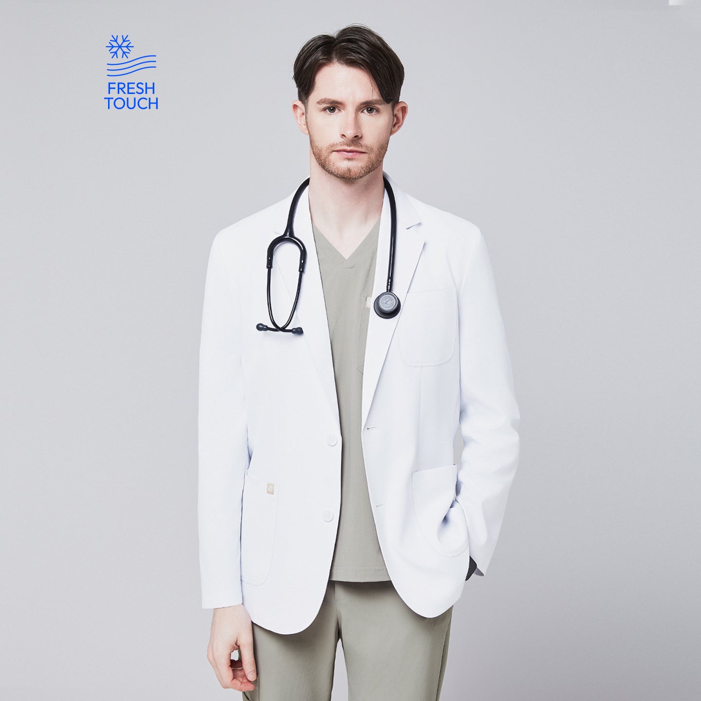 Front view of a male model wearing a white short lab coat over olive green scrub pants, showcasing clean and tailored design,White