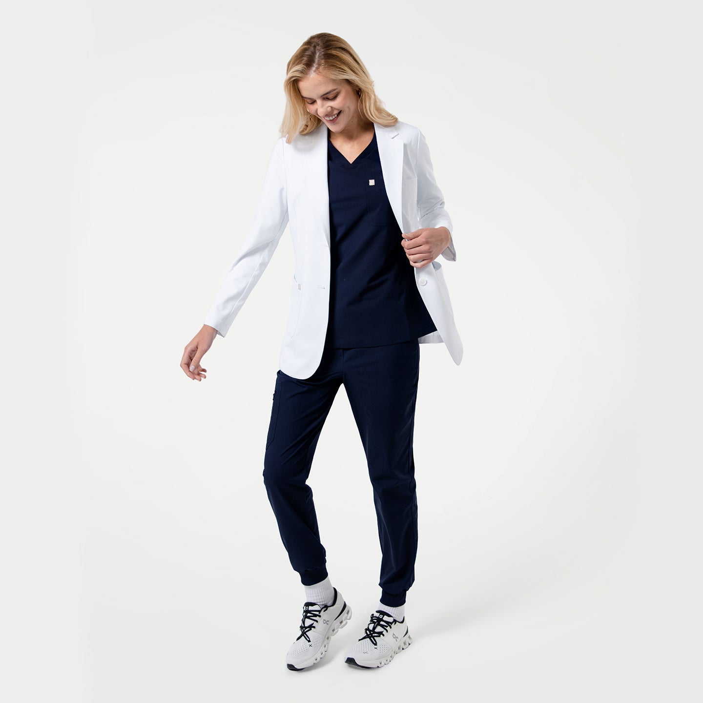 Women wearing a LCW-02 short white lab coat over a navy outfit on a white background